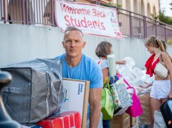 man pushing a full cart