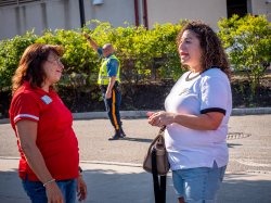 Dawn Soufleris talking with parent on campus