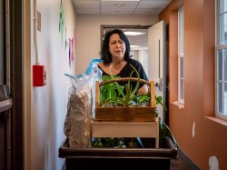 parent pushing cart in dormitory hallway