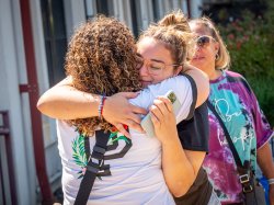 student hugging family member