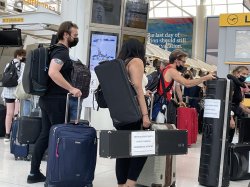 musicians at the airport with luggage and instrument cases