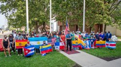 large group of student holding an array of flags from Latin countries