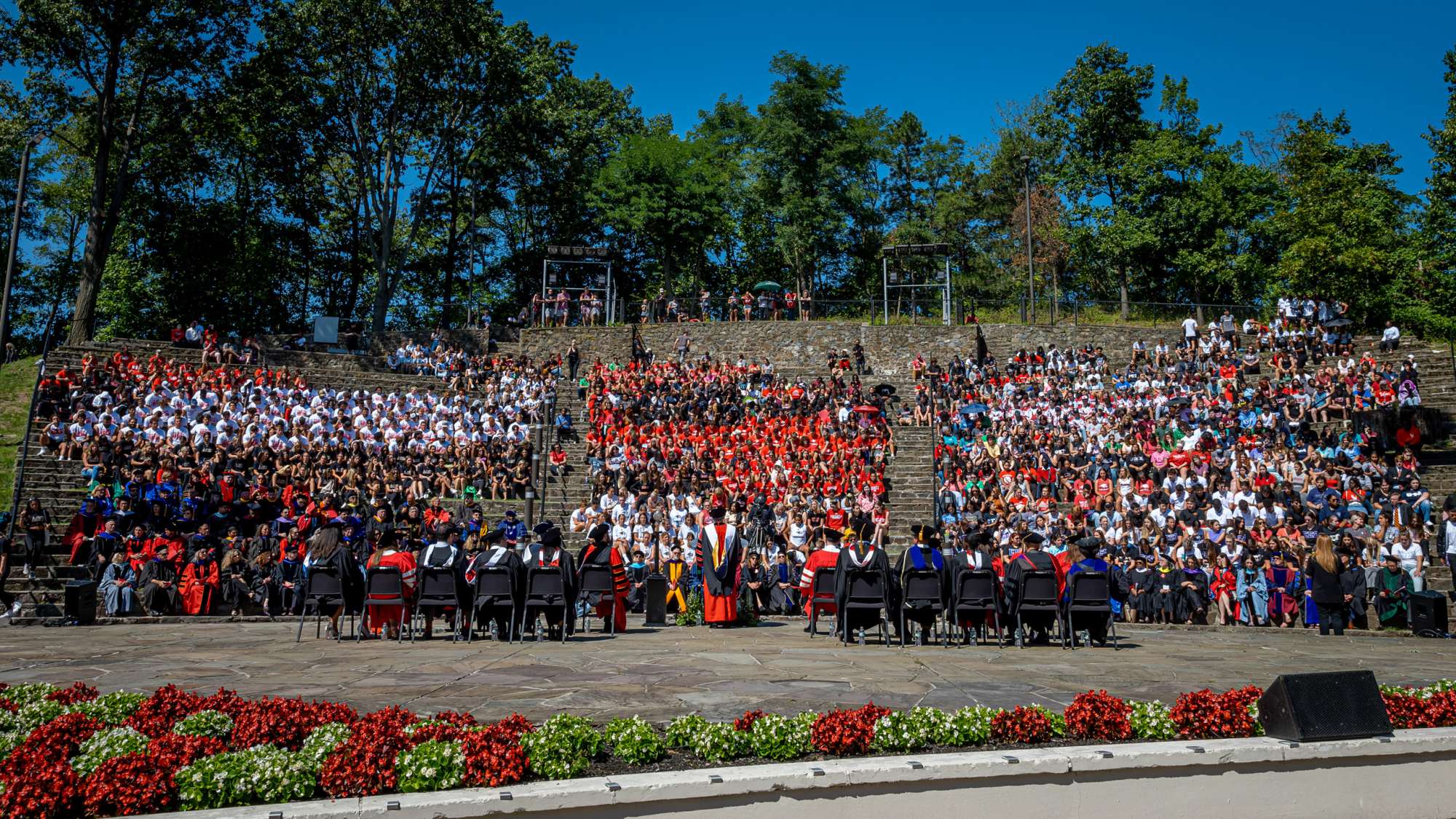 attendees seated in amphitheater on campus