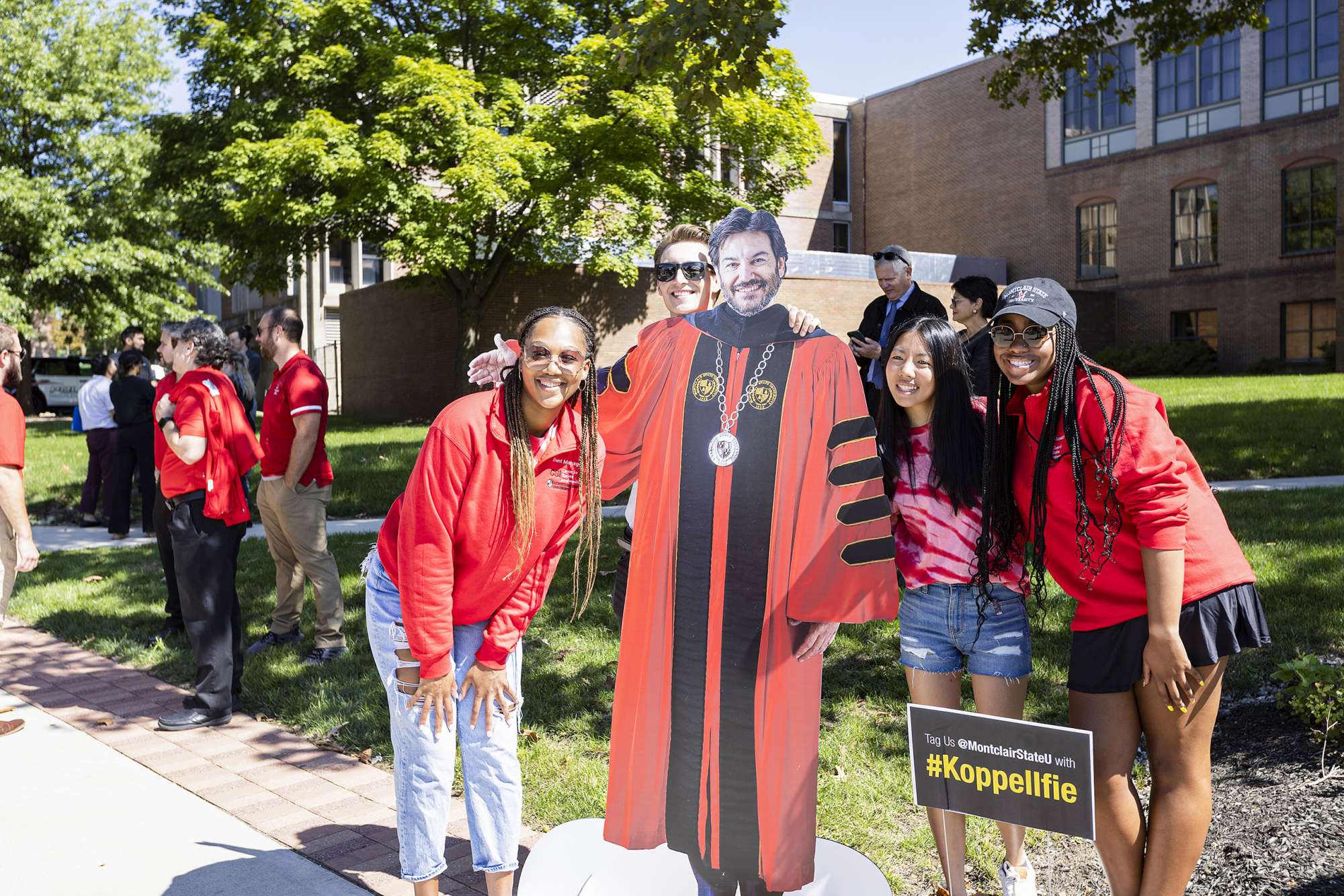 Students pose with a cutout of President Koppell