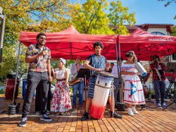 the Cali School’s Afro-Caribbean Ensemble on campus with microphone and drum