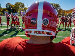 Photo of a the back of a Red Hawk's helmet with "Keep Pounding" printed along the bottom edge