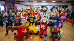 Crowd shot of Rocky with mascots and students in costumes