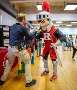 Man shaking hands with Rutgers knight