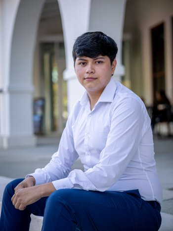 Student sitting on steps in front of kasser theater