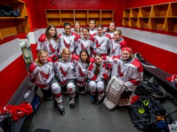 group photo of Montclair State University Women's Ice Hockey Team in locker room