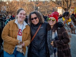 Three women smiling on campus