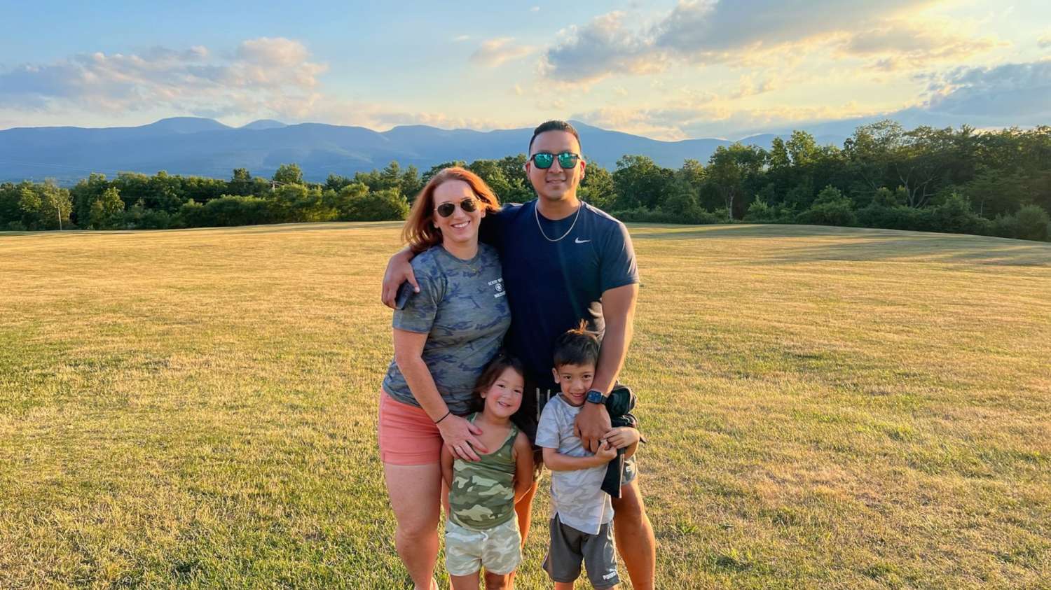 Man and woman pose with two young children.