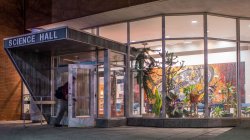 A building entrance with lights at night.