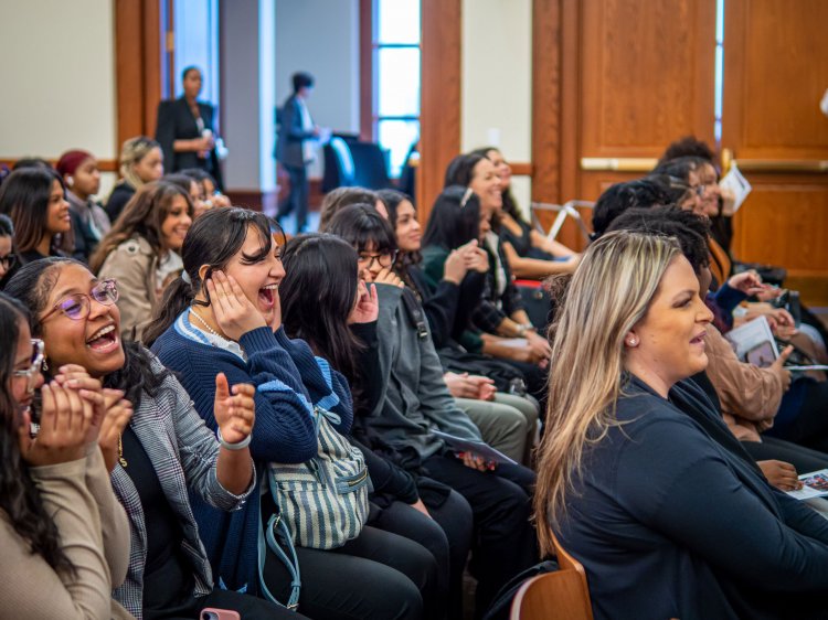 Conference attendees laughing and smiling during the talent show at the Young Women's Empowerment Conference.