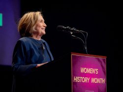 Woman speaks at a podium.