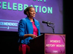 Woman speaks at a podium.