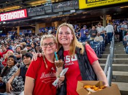 Two women wearing red Montclair tee shirts