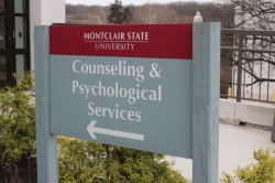 Campus sign that reads "Counseling and Psychological Services" with an arrow pointing left toward the building.