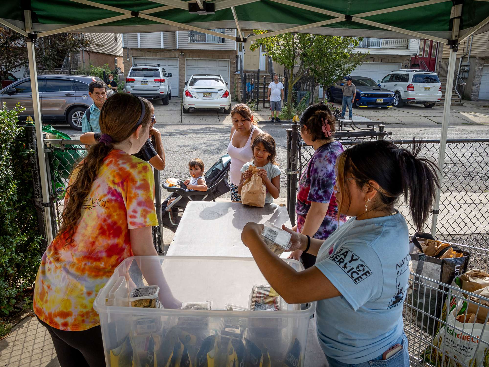 Students give a family a bag of food.