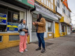 A man and woman talk in front of a Black Lives Matter storefront in Paterson, New Jersey.