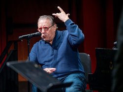 Arturo Sandoval gestures with both hands as he scat sings.