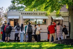 Students line up at a Starbucks coffee truck.