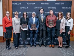 People who won awards pose for a photo with leaders on human trafficking.