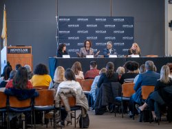 An audience listens to a panel of leaders on human trafficking.