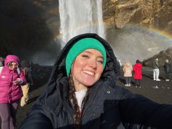A student takes a selfie photograph in front of Iceland’s Skógafoss waterfall.