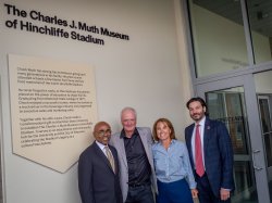 Baye Adofo Wilson, Charles J. Muth, Laura Muth and Jonathan Koppell stand in front of the information for The Charles J. Muth Museum of Hinchliffe Stadium.