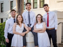 The Povolo quintuplets pose before a white building