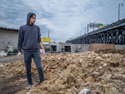 Godek looks out at the rooftop compost pile, where spent mushroom blocks break down into compost available to the community.