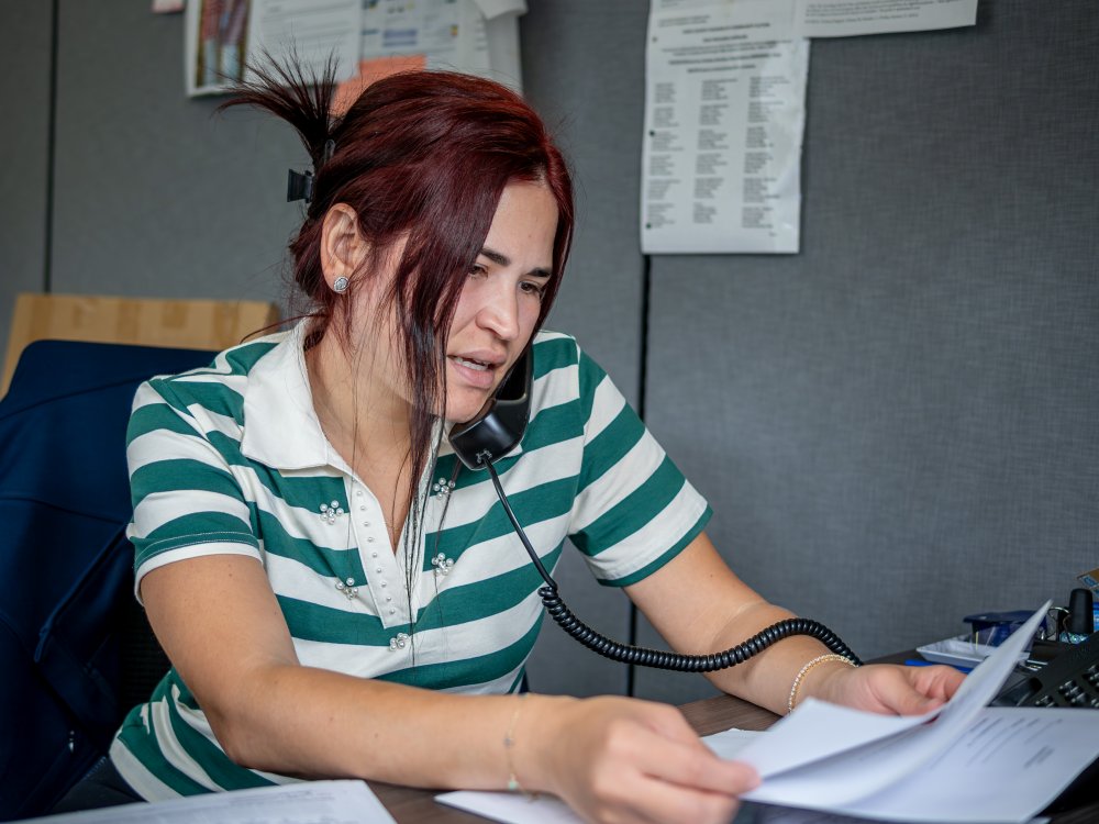 Oscaterin fields calls and reviews paperwork in her office at the Montclair Child Development Center,