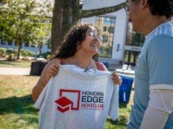 Sara Flores holds an Honors EDGE T-shirt.