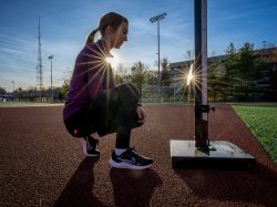 Olga Mikutina sets up a cell phone to connect her and her coach while she practices on the Montclair track.