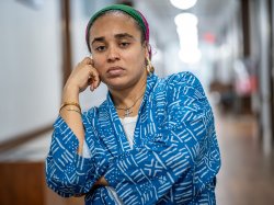 Cookie Howard poses, leaning her face into her hand.