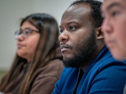Horatio Wauchope in a classroom setting, with two students on either side of him.