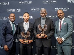 From left, Rahjaun Gordon, Tommy Foster, Leslie Wilson and Daniel Jean stand together; Foster and Wilson are holding their Trailblazer awards.