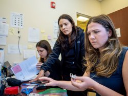 Director of the New Jersey Hearing Aid Project Elena Kagan-Weitz supervises Montclair State University Audiology students Julianna Mijal and Emma Simas as they work on hearing aids.