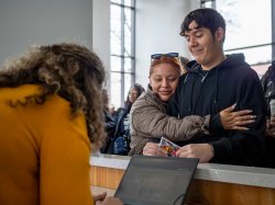 A mother hugs her son who has been accepted to Montclair State University.