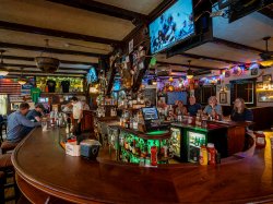 Patrons sit around a bar at Tierney’s.