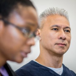 Photo of male nurse with out-of-focus female nurse.