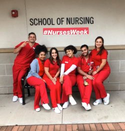 Six students from the 4-year BSN Program sitting outside the School of Nursing building.