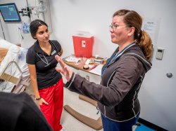 School of Nursing professor with nursing student in the Simulation Center.