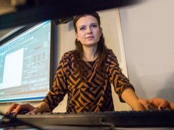 Teacher in classroom using computer