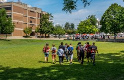 Group of students walking on grass at orientation