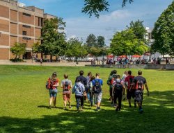 Group of students walking on grass at orientation