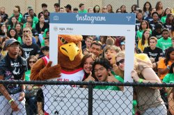 Students posing for a photo with Rocky the Red Hawk.