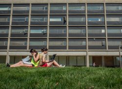 two students sitting on the lawn outside Blanton Hall