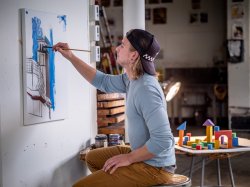 Student painting University Hall.